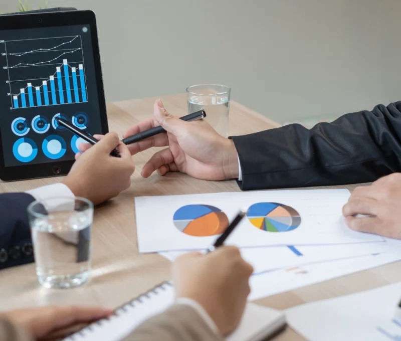 executives sitting around table reviewing 360 degree leadership assessment survey results